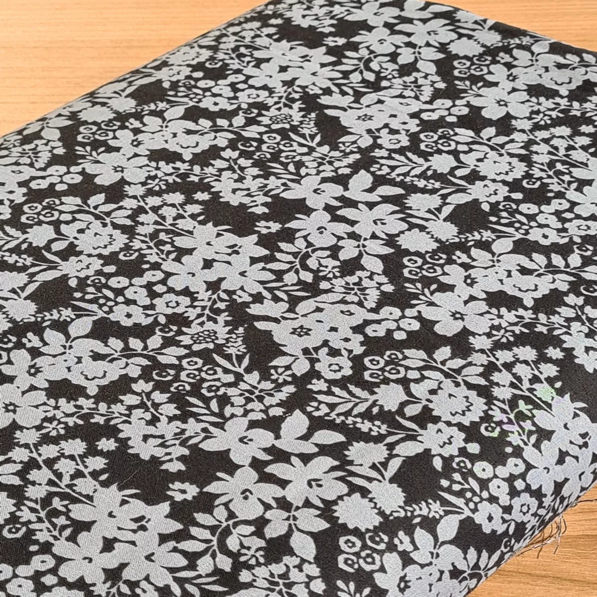 "Flower carpet" on black background by Kokka brand (price per 10cm)